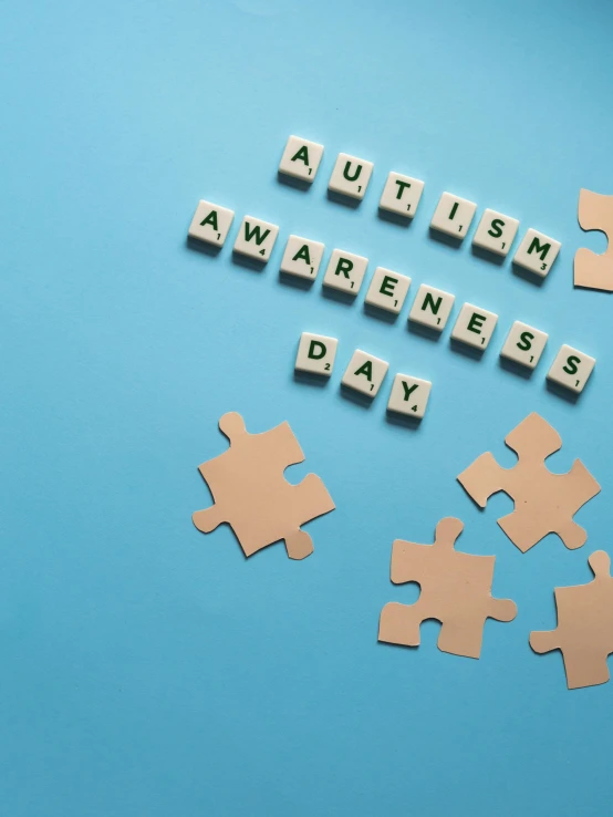 puzzle pieces spelling autism awareness day on a blue background, shutterstock, jen atkin, square, stunning visuals, can