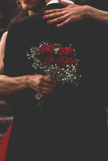 a man standing next to a woman holding a bouquet of flowers, inspired by Elsa Bleda, pexels, black and red dress, dark. no text, non-binary, made of flowers