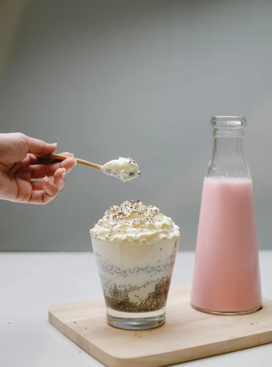 a person dipping a spoon into a glass of milk, by Tan Ting-pho, cupcake, full of sand and glitter, medium height, grey