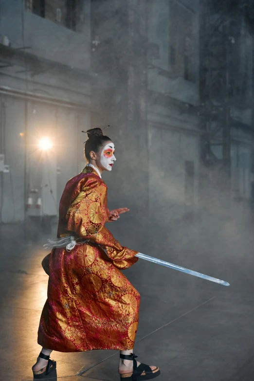 a woman dressed as a geisha with a sword, inspired by Fu Baoshi, baroque, facing off in a duel, production photo, court jester, ( ( theatrical ) )