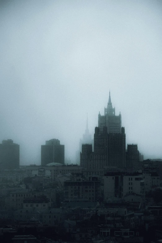 a black and white photo of a city in the fog, an album cover, inspired by Katia Chausheva, unsplash contest winner, kremlin, desaturated color, skyline, soviet apartment buildings