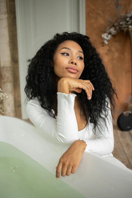 a woman sitting in a bathtub with her hand on her chin, trending on pexels, renaissance, doja cat, sza, looking confident, morning time