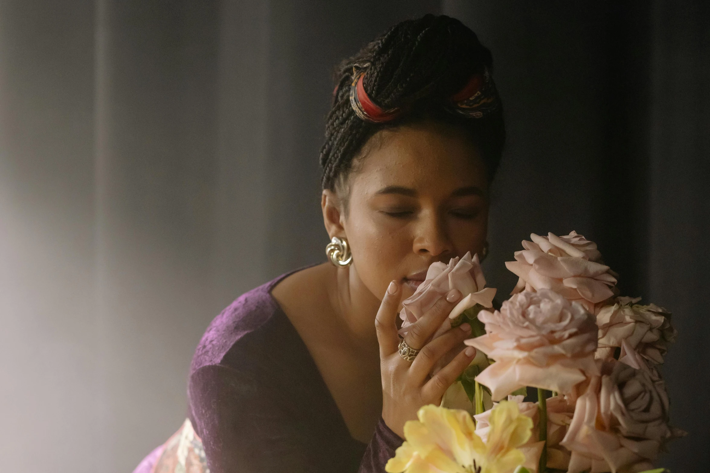 a woman holding a bouquet of flowers in front of her face, an album cover, inspired by Carrie Mae Weems, pexels contest winner, romanticism, tessa thompson inspired, soft light.4k, wearing pink floral chiton, movie still 8 k