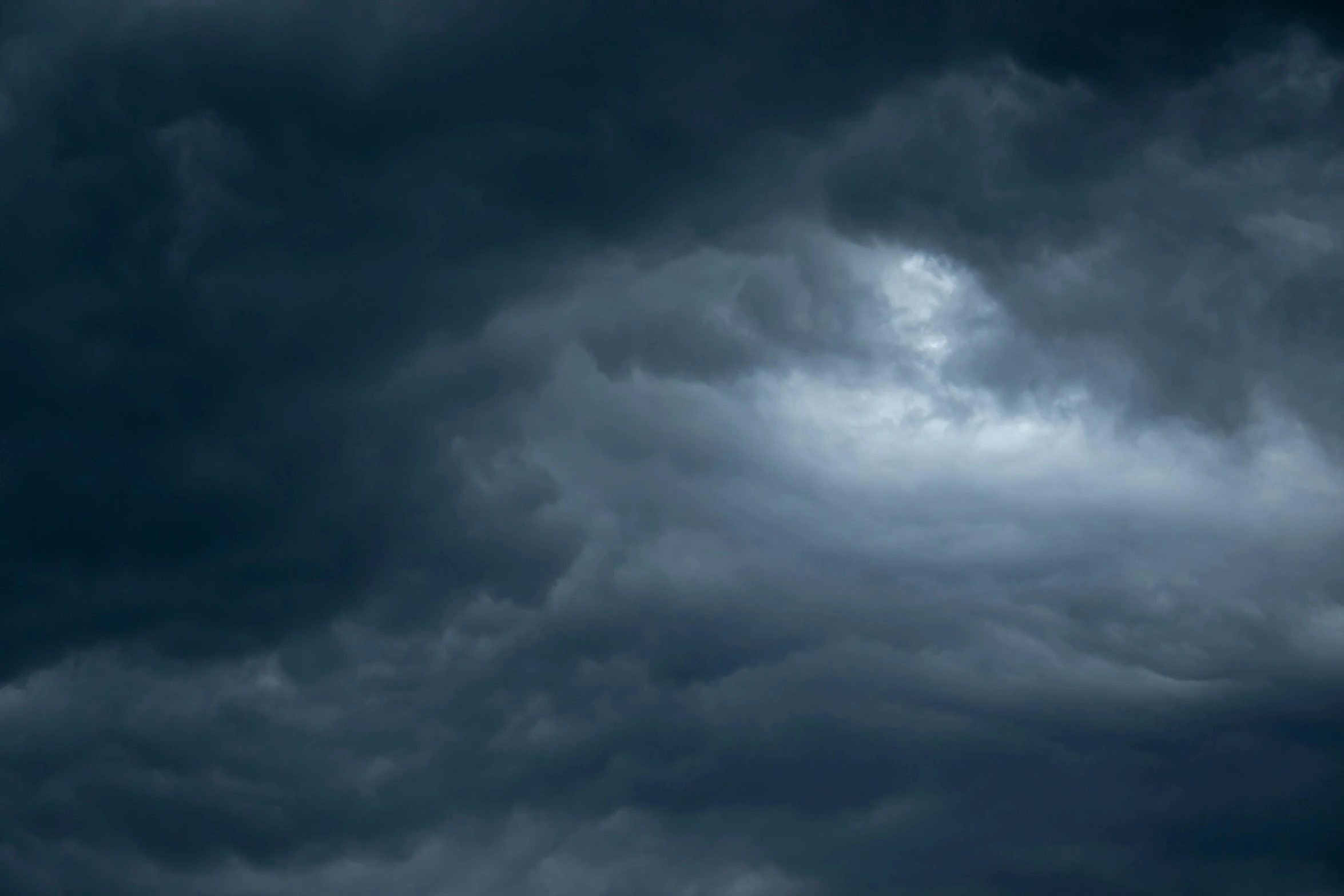 a plane flying through a dark cloudy sky, pexels, baroque, a violent storm at sea, dull blue cloudy background, rectangle, grey