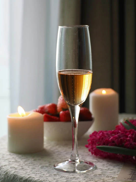 a glass of wine sitting on top of a table, a still life, by Valentine Hugo, pexels, romanticism, white candles, promo image, bubbly, 15081959 21121991 01012000 4k