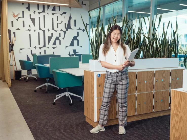 a woman standing next to a desk in an office, darren quach, uhq, patterned, office furniture