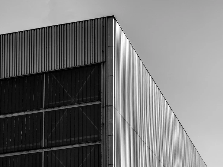 a black and white photo of a building, by Matthias Weischer, pexels contest winner, postminimalism, grey warehouse background, square lines, metal panels, industrial colours