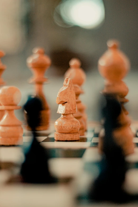 a group of chess pieces sitting on top of a chess board, a tilt shift photo, unsplash, synthetism, brown, dynamic closeup, instagram post, half image