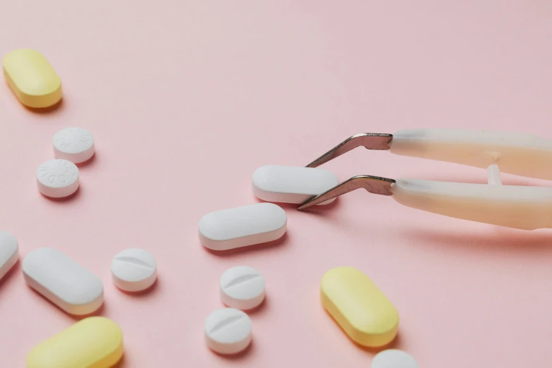 a pair of pliers and some pills on a pink surface, trending on pexels, antipodeans, mary jane ansell, bending down slightly, pastel colored, cut-away