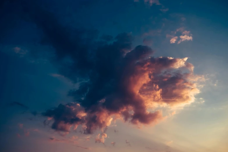 there is a large cloud that is in the sky, unsplash, romanticism, muted blue and red tones, evening lighting, frank moth, low-angle