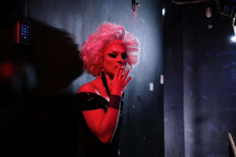 a woman with pink hair smoking a cigarette, inspired by Nan Goldin, pexels, transgressive art, performing on stage, drag, neon operator margot robbie, production photo