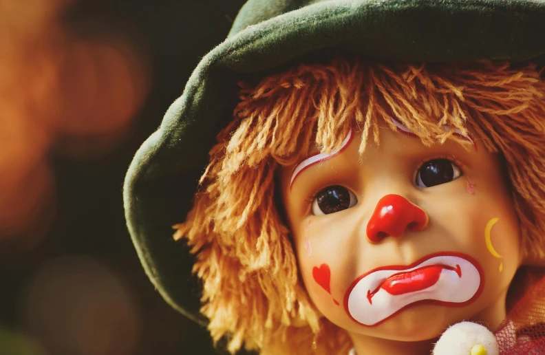 a close up of a doll with a clown face, trending on pixabay, lowbrow, square, toddler, costume, a green