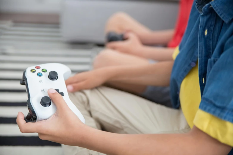 a close up of a person holding a video game controller, a picture, schools, sitting down, kids playing, avatar image