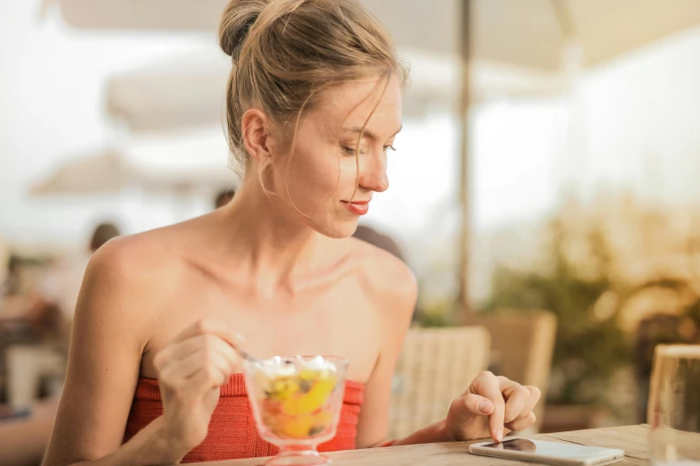 a woman sitting at a table eating an ice cream sundae, pexels contest winner, smooth healthy skin, at the terrace, avatar image, profile image