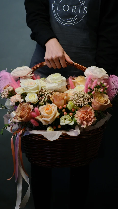 a person holding a basket full of flowers, a pastel, by Miroslava Sviridova, pexels, on a dark background, in shades of peach, fully decorated, soft and fluffy