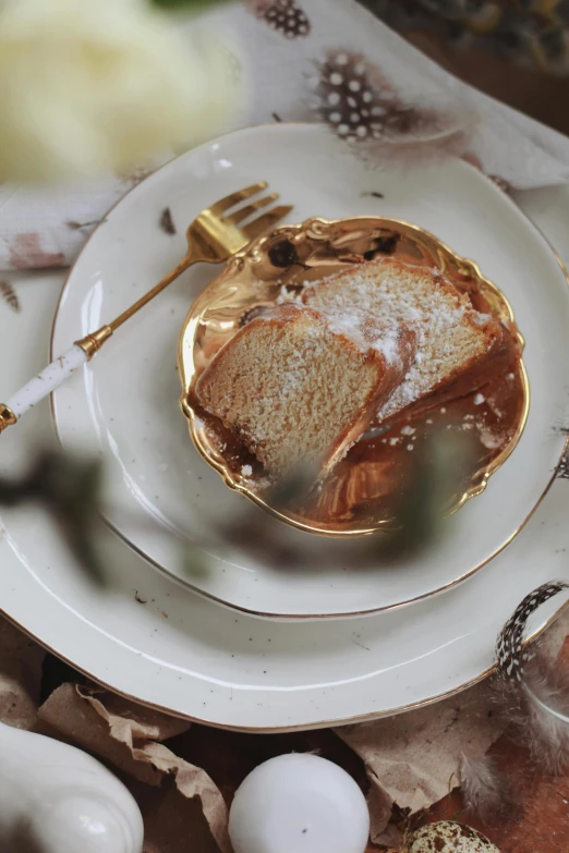 a close up of a plate of food on a table, baroque, cake, profile image, subtle gold accents, caramel. rugged