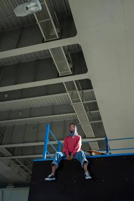 a man riding a skateboard up the side of a ramp, a portrait, unsplash, hyperrealism, sitting in a crane, as she looks up at the ceiling, ameera al-taweel, production photo