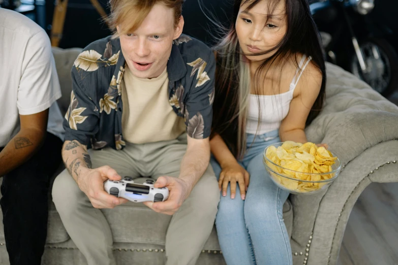 a group of people sitting on a couch playing a video game, by Adam Marczyński, pexels, hyperrealism, mukbang, medium shot of two characters, 😭🤮 💔, male and female