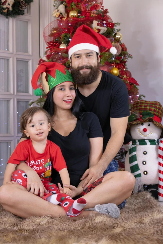 a family sitting in front of a christmas tree, a portrait, reddit, 3 5 year brazilian mother, bearded, official photo, profile picture 1024px