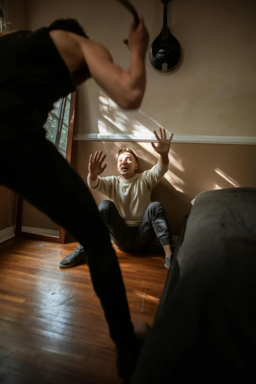 a man standing next to a woman in a living room, a picture, trending on pexels, violently fist fighting, crawling out of a dark room, teenage boy, sun behind him