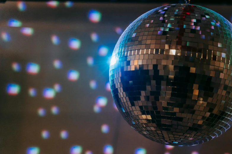 a disco ball hanging from the ceiling, pexels, holography, line dancing at a party, paul barson, flirting, 1970s photo