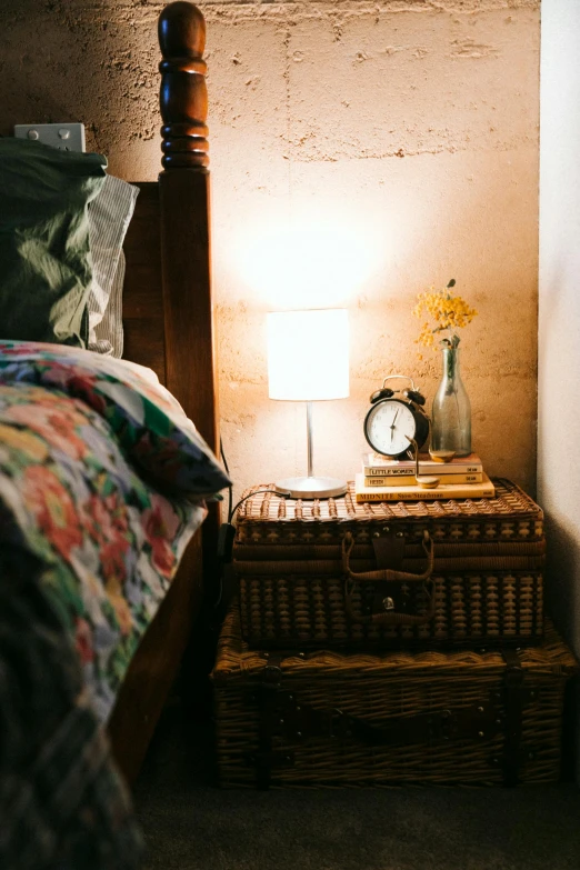 a bed room with a neatly made bed and a night stand, a portrait, inspired by Elsa Bleda, unsplash, vintage photo, lamps and flowers, an escape room in a small, sydney hanson