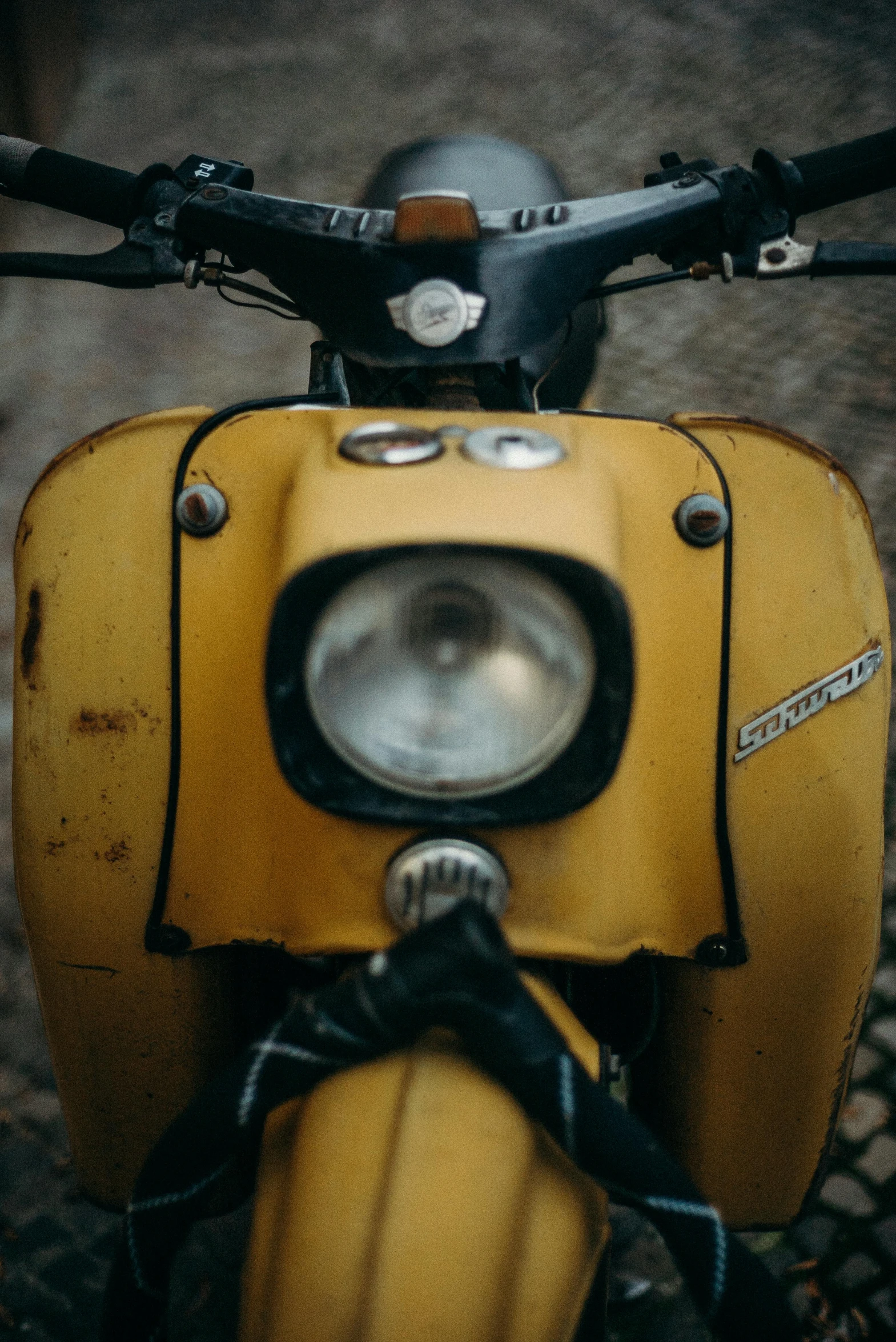 a close up of a yellow motor scooter, by Sven Erixson, unsplash, slightly dirty face, historical, headlights, nostalgic 8k