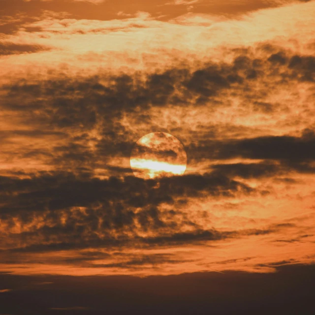 the sun is setting behind the clouds in the sky, pexels contest winner, romanticism, dark orange night sky, instagram post, brown, full moon in clouds