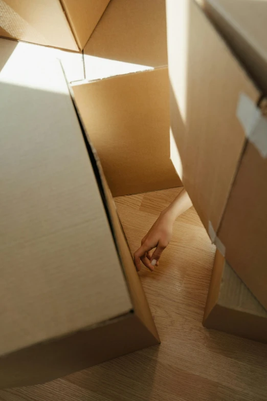 a couple of boxes sitting on top of a wooden floor, profile image, opening door, ignant, close - up photograph