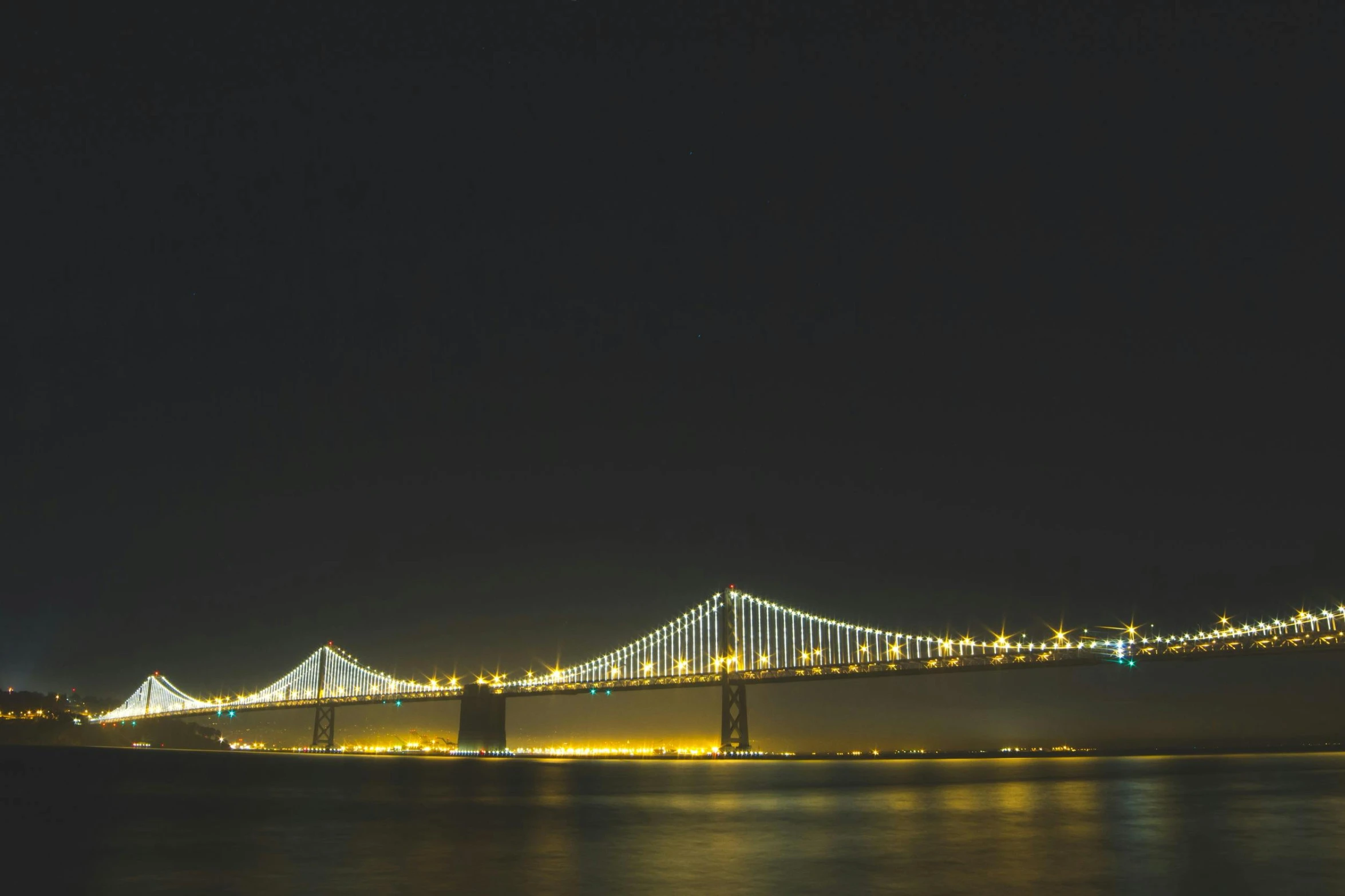 the bay bridge is lit up at night, unsplash contest winner, renaissance, 1980s photo, fan favorite, minimalist photo, city view