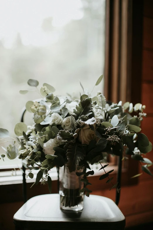 a vase of flowers sitting on a table in front of a window, by Jessie Algie, unsplash, pale greens and whites, forest details, bouquet, modern rustic