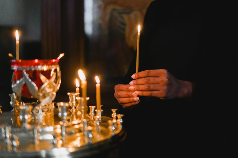 a close up of a person holding a lit candle, orthodoxy, profile image, scepter, multiple stories