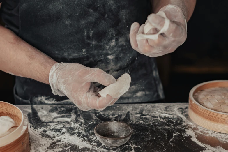 a close up of a person preparing food on a table, clay material, thumbnail, pastry, lachlan bailey