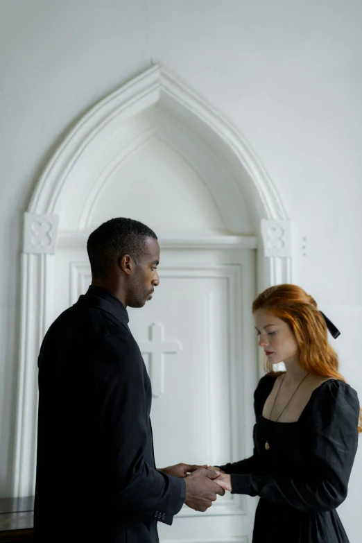 a man and woman shaking hands in front of a door, inspired by Gordon Parks, international gothic, sadie sink, looking away, on the altar, black supremacy