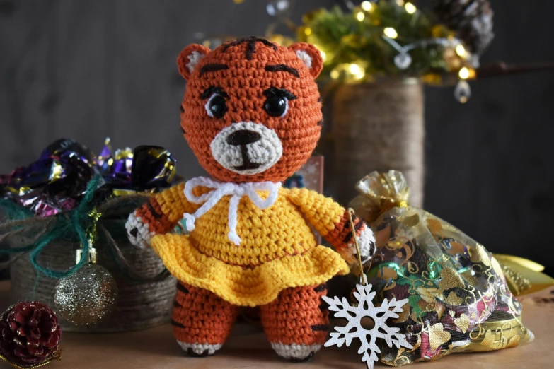 a crocheted teddy bear wearing a yellow dress, a portrait, by Ivana Kobilca, pexels, tigers, christmas, orange, detailed scene