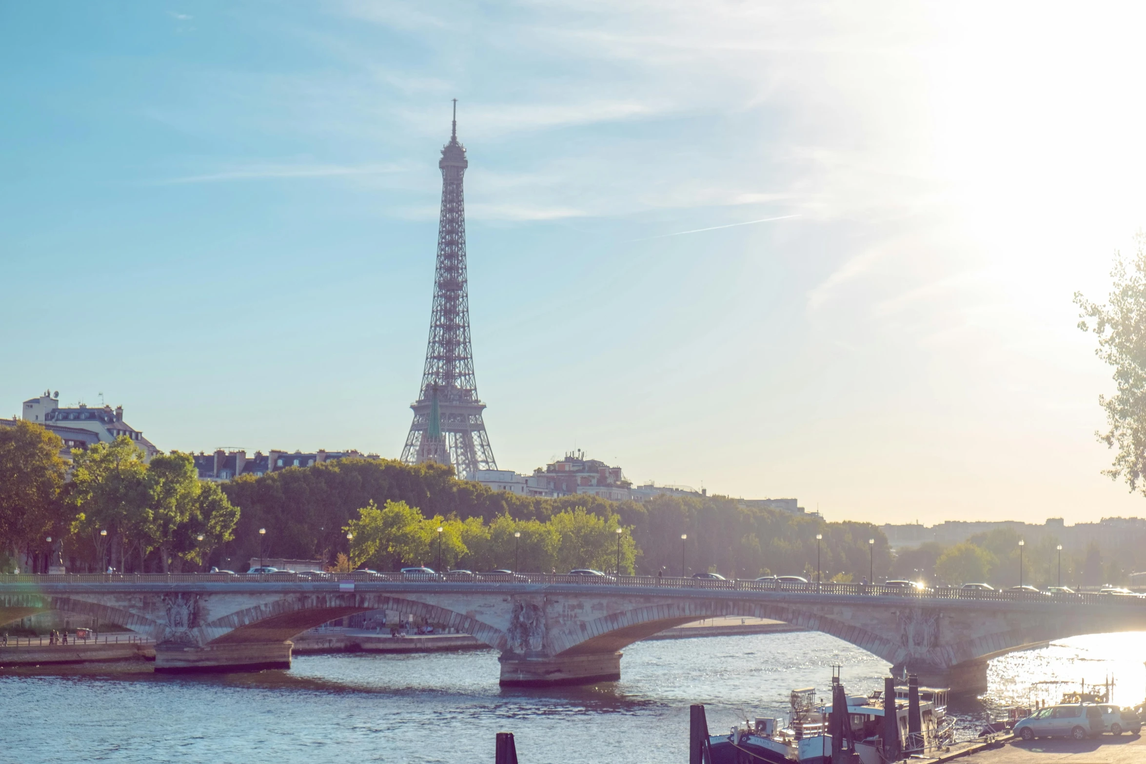 a view of the eiffel tower from across the river, pexels contest winner, sunny light, ad image, multiple stories, slide show