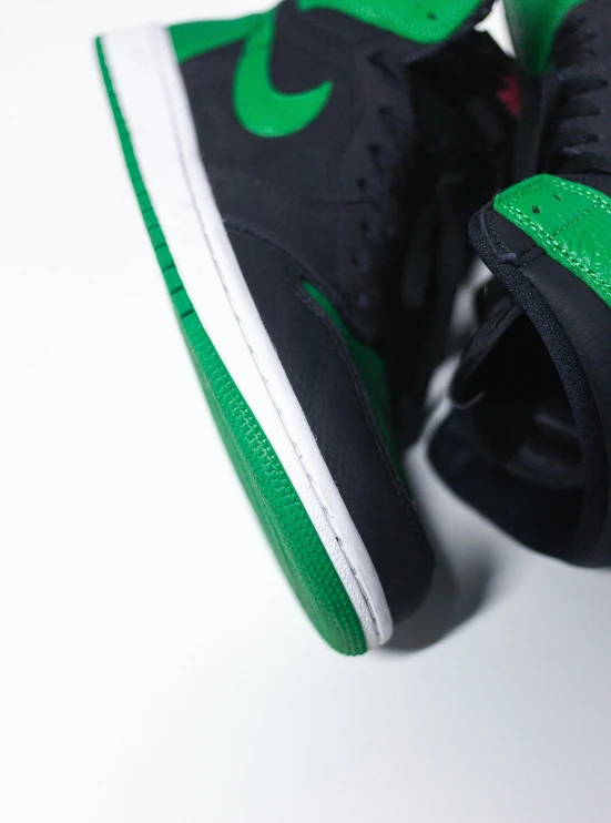 a pair of black and green sneakers on a white surface, a picture, by Paul Bird, unsplash, red and green, high-body detail, “air jordan 1, detailed color scan