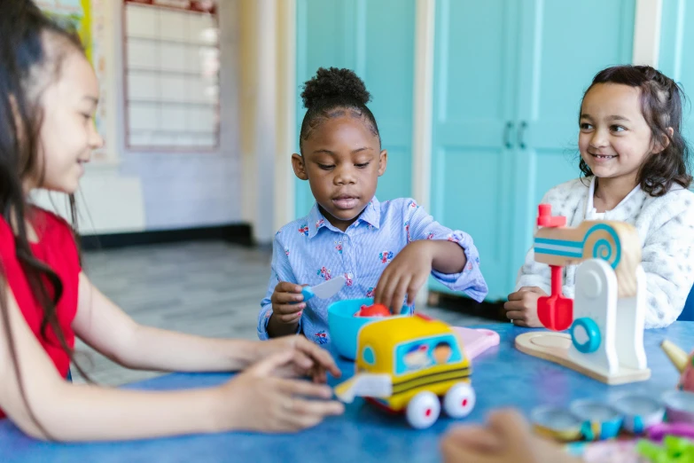 a group of children sitting at a table playing with toys, pexels contest winner, american barbizon school, light skinned african young girl, girl wearing uniform, 15081959 21121991 01012000 4k, thumbnail