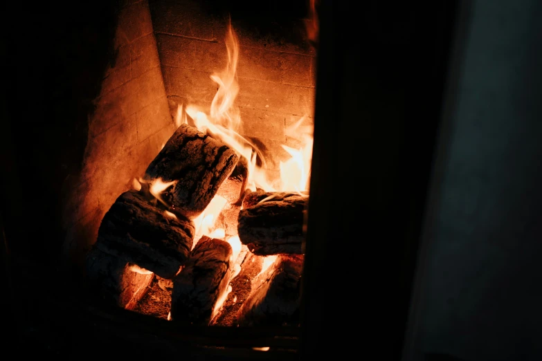 a close up of a fire in a fireplace, pexels contest winner, moody evening light, a wooden, multiple stories, mid riff