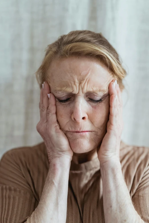 a woman holding her head in her hands, aging, bruised face, lynn skordal, multi-part