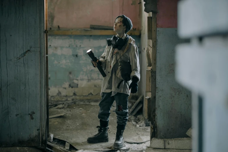 a man that is standing in a room, inspired by Ismail Inceoglu, pexels contest winner, graffiti, dressed as a scavenger, postapocalyptic, kim doyoung, awardwinning movie still