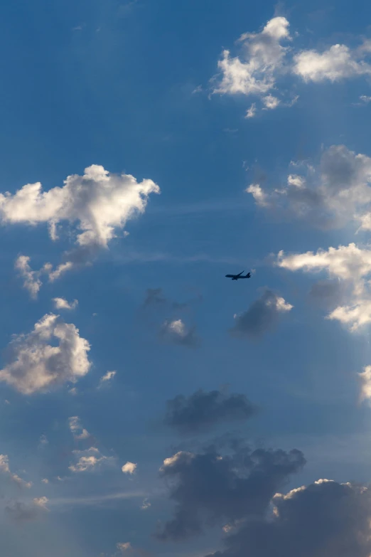 a plane flying through a cloudy blue sky, by Niko Henrichon, f/2, evening sunlight, f / 2, low detail