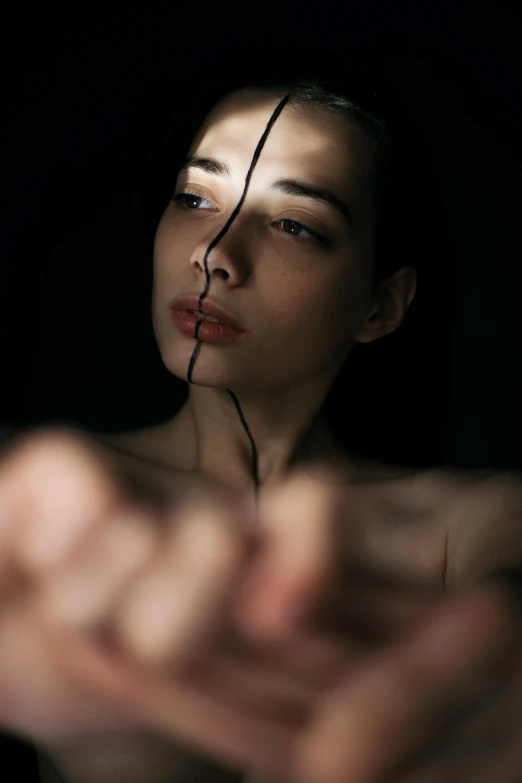 a woman holding a knife in front of her face, by Adam Marczyński, pexels contest winner, hyperrealism, kintsugi, light and dark, connecting lines, image split in half