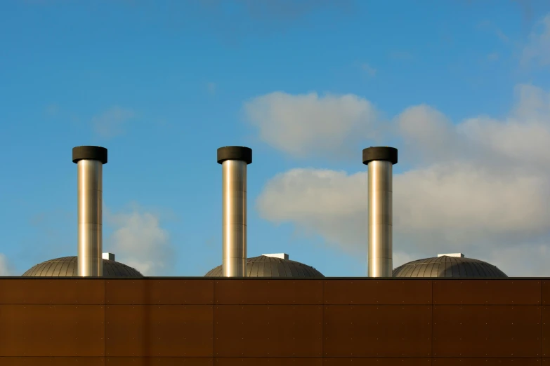 three smoke stacks on top of a building, inspired by Patrick Caulfield, unsplash, brutalism, brown, datacentre, maintenance photo