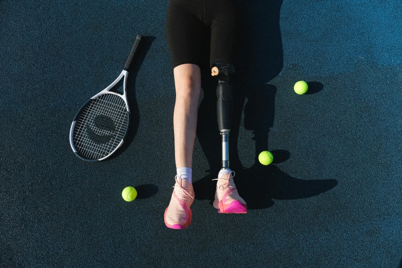 a woman holding a tennis racquet on top of a tennis court, unsplash, realism, prosthetic leg, two crutches near bench, wearing kneesocks, a brightly coloured