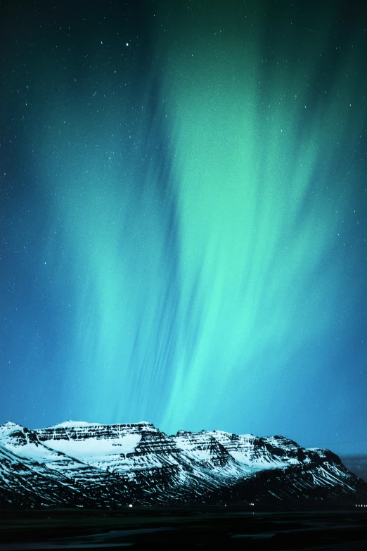 the aurora lights in the sky over a snow covered mountain, by Jesper Knudsen, pexels contest winner, surrealism, blue sky, panels, iceland hills in the background, neon blue and yellow lights