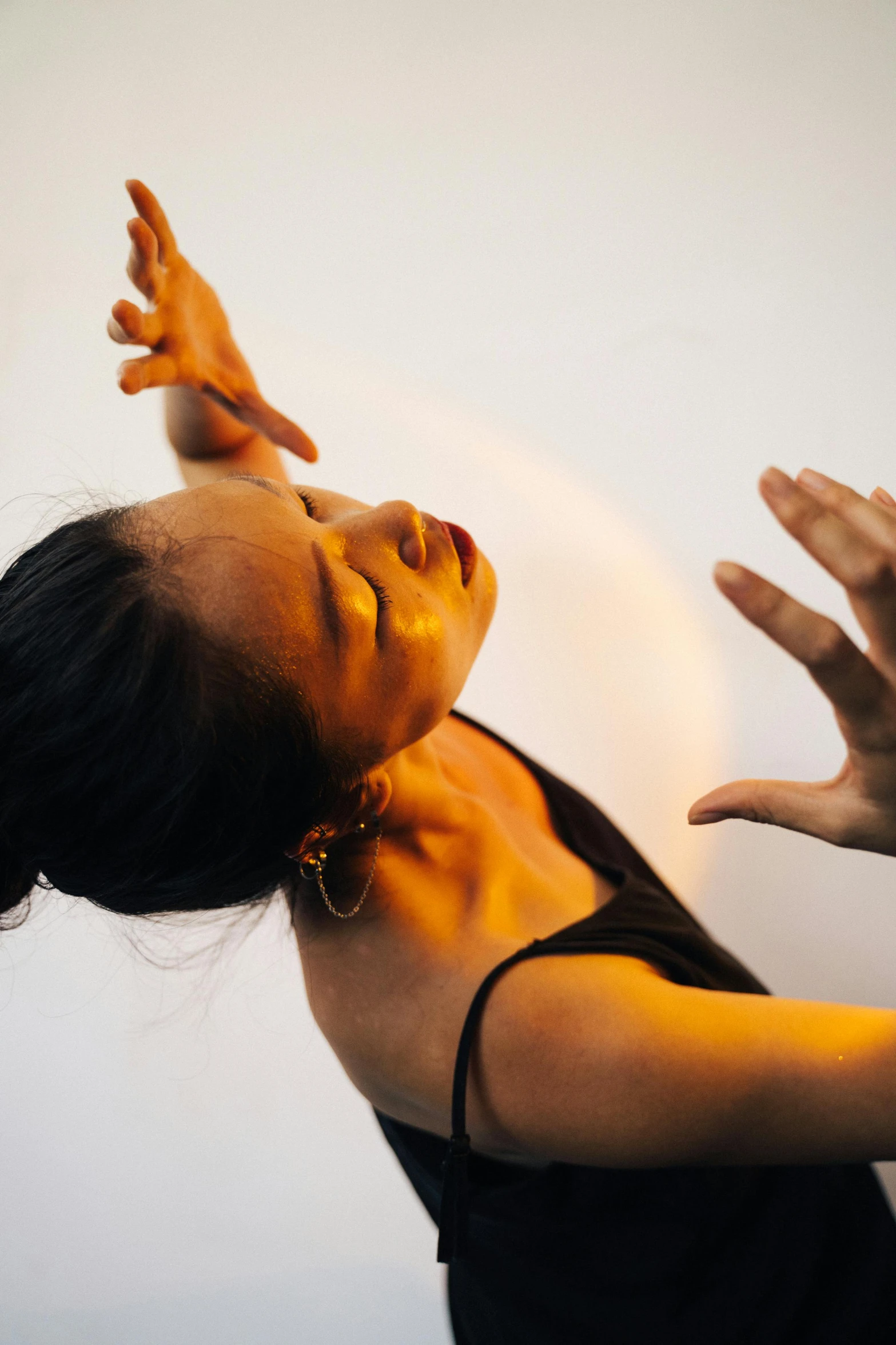 a woman reaching up to catch a frisbee, inspired by Fei Danxu, arabesque, hands on face, contemporary dance, light and dark