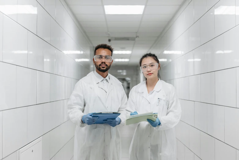 two people in lab coats standing next to each other, pexels contest winner, wet floors, holding a clipboard, bao pham, thumbnail