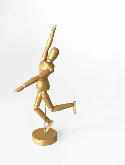 a gold statue of a man holding a tennis racquet, by Arabella Rankin, kinetic art, 12in action figure, dancing a jig, wooden statue, pose(arms up + happy)
