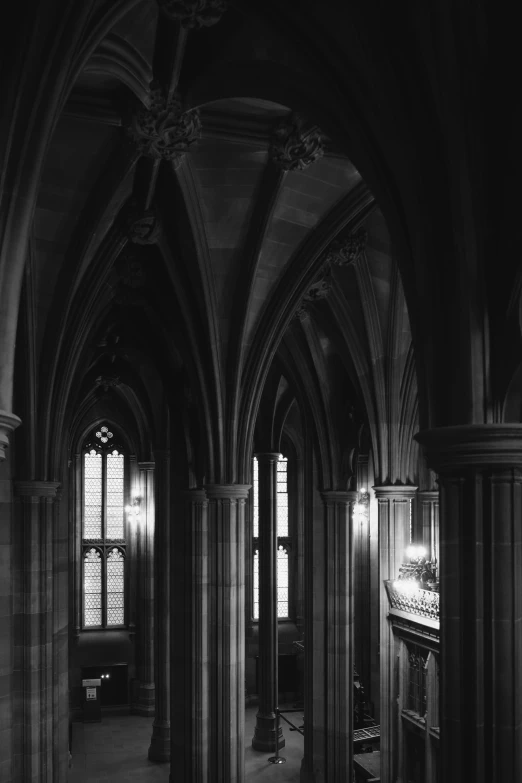 a black and white photo of the inside of a building, inspired by Sydney Prior Hall, gothic art, soft lighting from above, interior of a small, dark university aesthetic, medium format. soft light